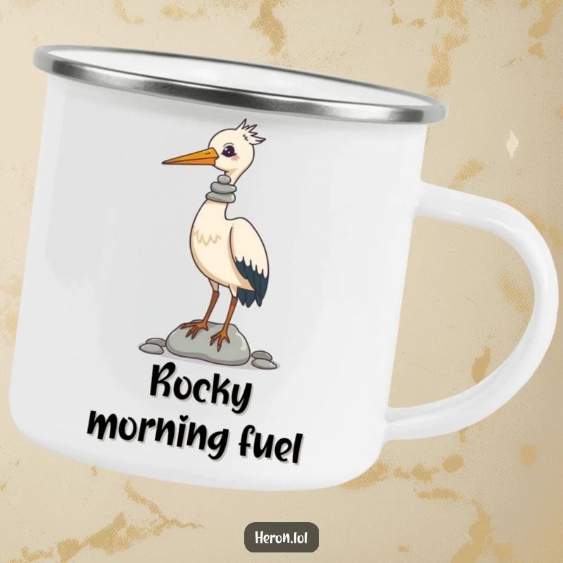 Funny Camping Mug showing a focused heron balancing a comical stack of pebbles on its beak, perfect for sipping beverages outdoors with a smile.