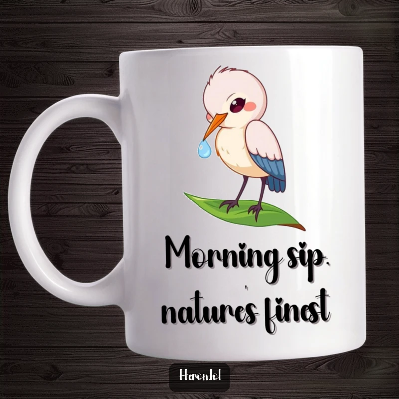 Funny mug featuring a playful heron bird delicately dipping its beak into a glistening dewdrop on a fresh green leaf.