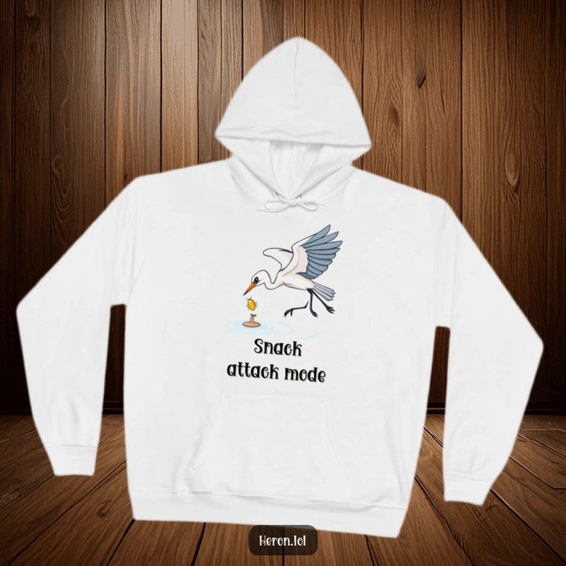 Funny Hoodie showcasing a heron gracefully swooping down to catch a shiny bug, combining warmth with a depiction of focused, humorous predation.
