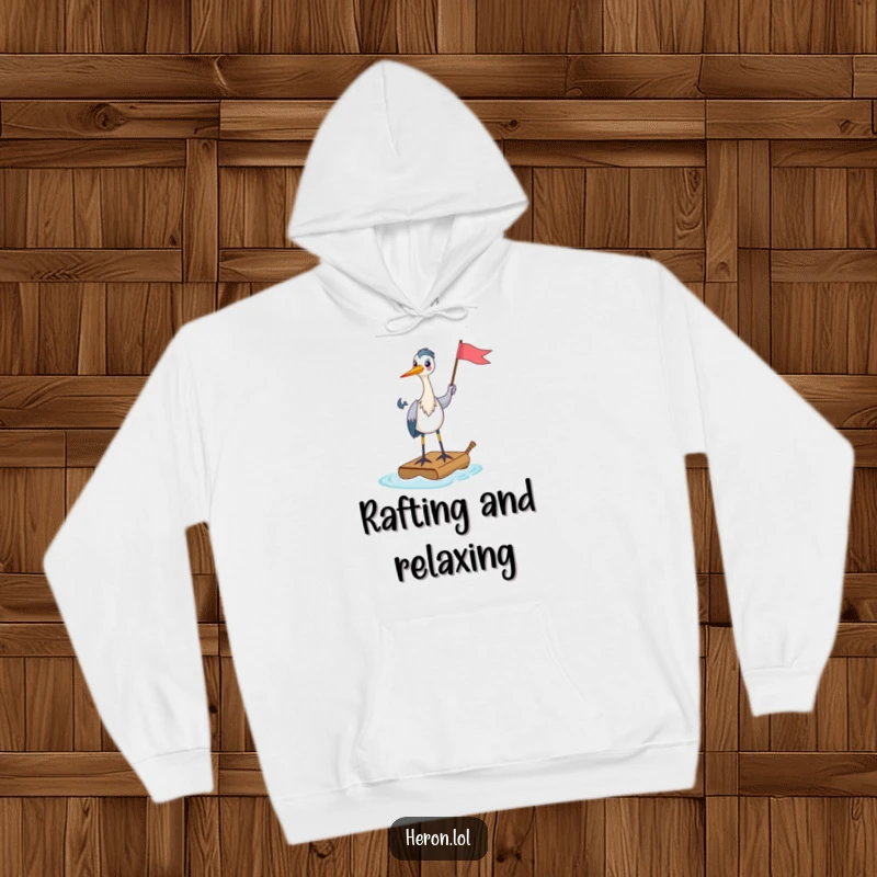 Funny Hoodie with a happy heron standing on a tiny raft, holding a flag aloft, representing cheerful leadership and humorous voyages.