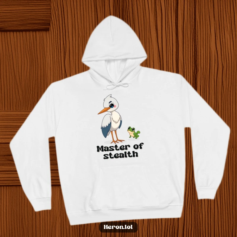 Funny Heron Hoodie: A sly heron with a wide grin watches a tiny frog make a daring leap to escape.