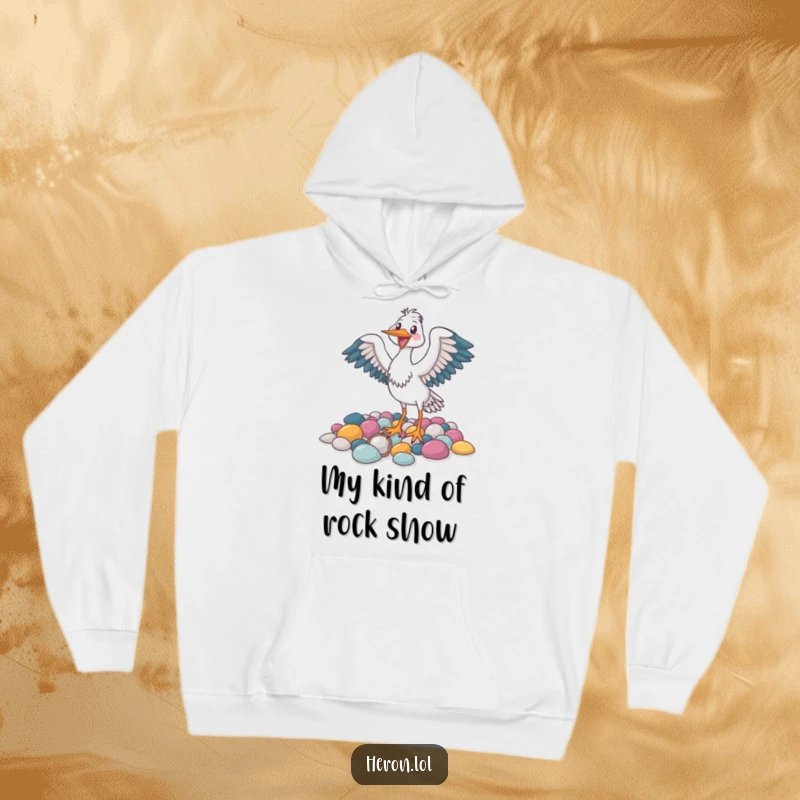 Funny hoodie featuring a joyful heron bird flapping its wings amongst colorful pebbles, offering comfort and smiles.