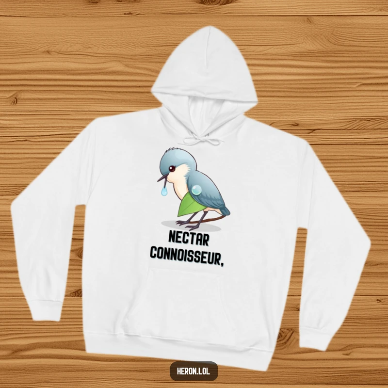 Funny Hoodie depicting a heron meticulously pecking a dewdrop on a leaf, offering warmth and a chuckle to the wearer and onlookers.