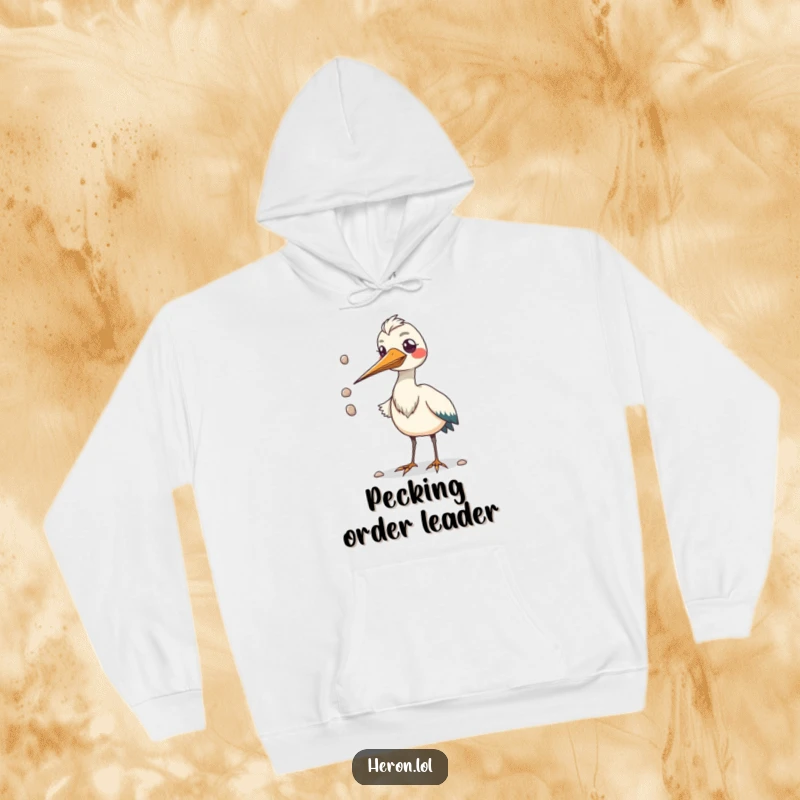 Funny hoodie depicting a kawaii heron bird with a comically large beak juggling pebbles, offering warmth and laughter.