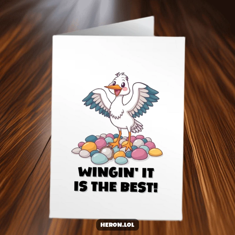 Funny Free Printable Birthday Card: A joyful heron bird flapping its wings amidst colorful pebbles.