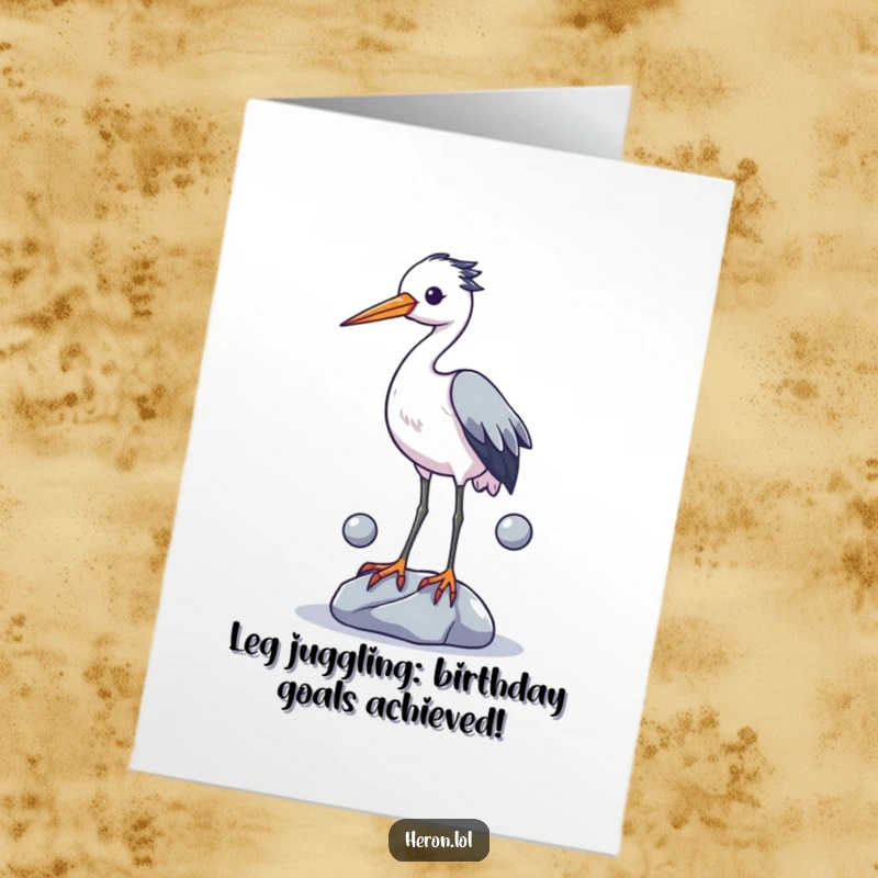 Funny free printable birthday card featuring a heron clumsily juggling stones with its legs, looking utterly confused and delighted.