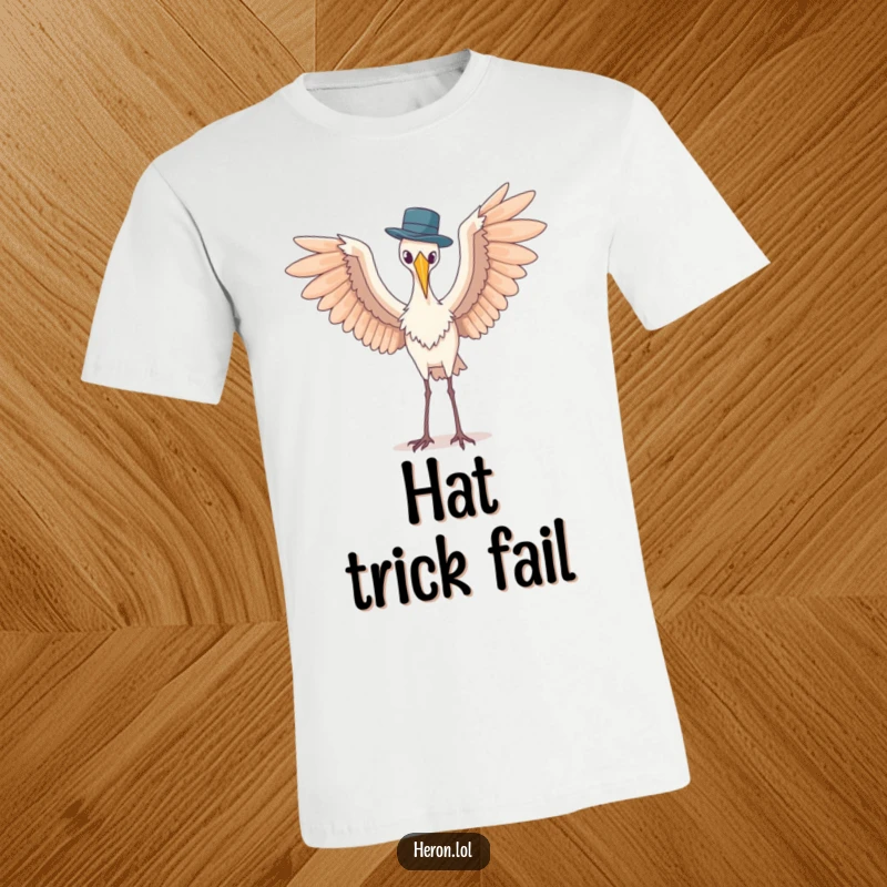 Funny t-shirt displaying a heron with wide-spread wings in an awkward pose, trying to balance a small hat, a comical sight.
