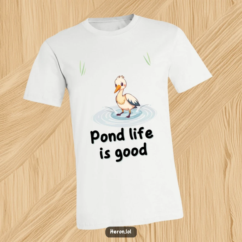 Funny heron t-shirt depicting a bird playfully splashing in a shimmering pond, a humorous and energetic design.