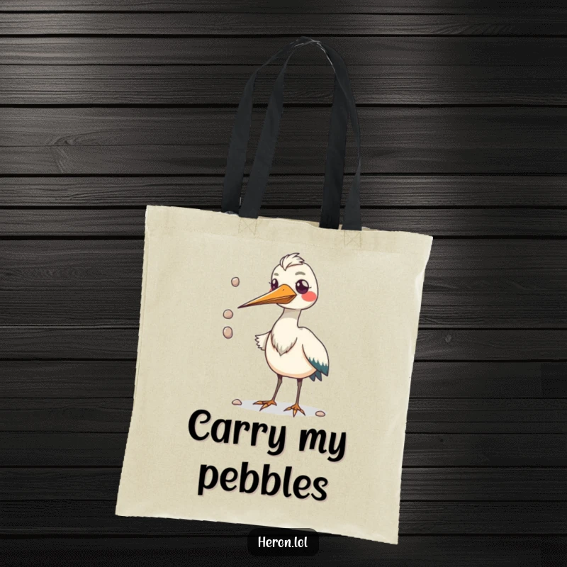 Funny tote bag featuring a kawaii heron bird with a huge beak juggling small pebbles, perfect for carrying essentials with humor.