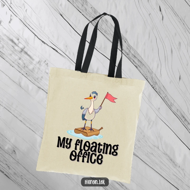 Funny Tote Bag illustrating a happy heron standing on a tiny raft, holding a flag, perfect for carrying items with a message of cheerful ambition.